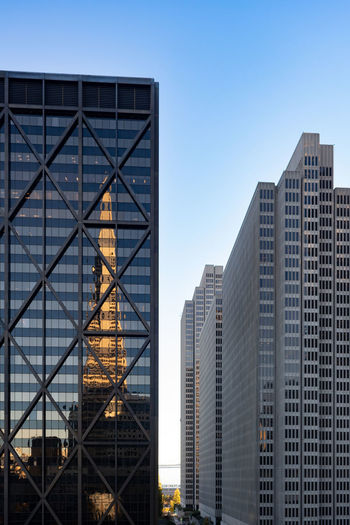 Low angle view of skyscrapers with reflection