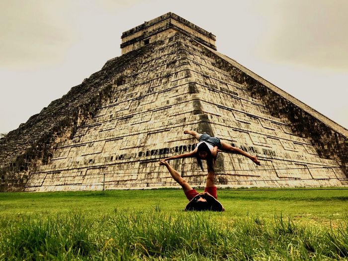 Couple exercising on grass by el castillo