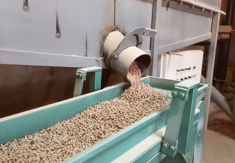 Meat spilling from machinery in container