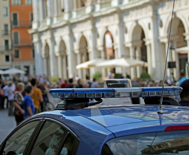Police car with blue sirens while patrolling an area of the european city