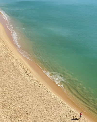 Aerial view of woman standing at beach