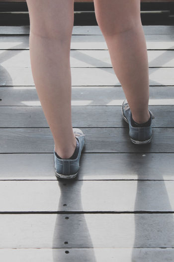 Low section of woman standing on deck