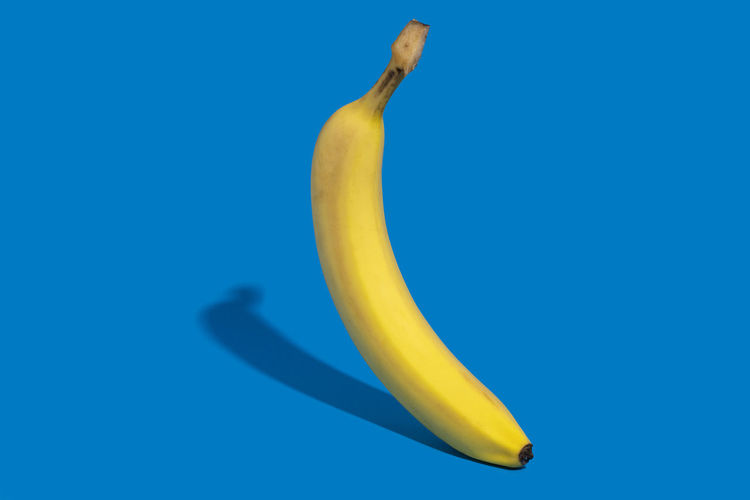 Close-up of banana against blue background