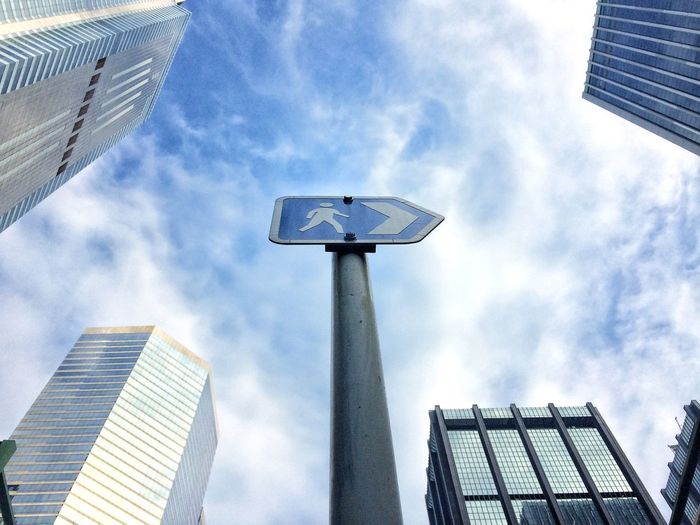 Low angle view of modern building against cloudy sky