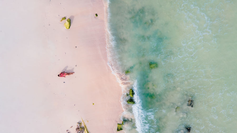 Aerial view of woman lying at beach