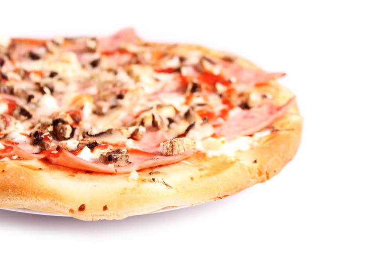 Close-up of pizza over white background