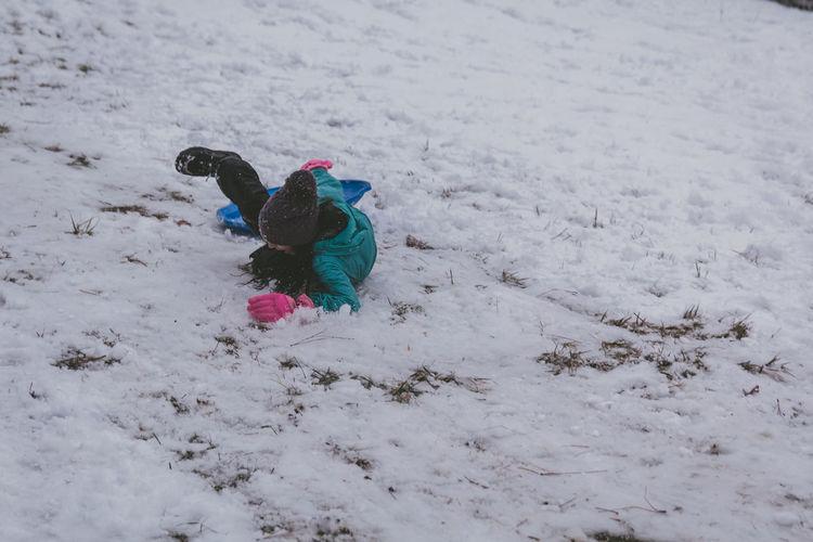 Girl playing on snow covered field