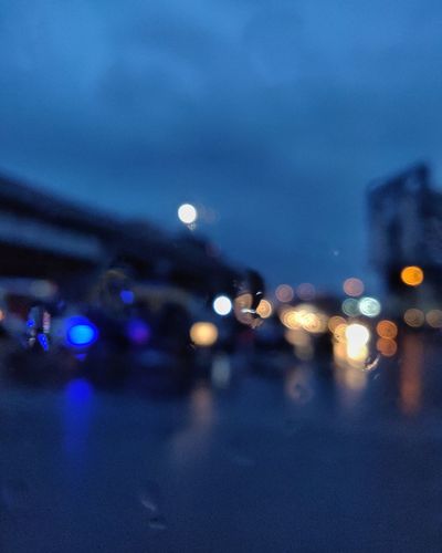 Defocused image of illuminated street at night