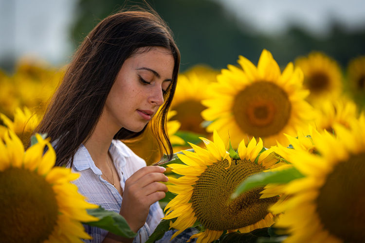 Full length of woman holding sunflower