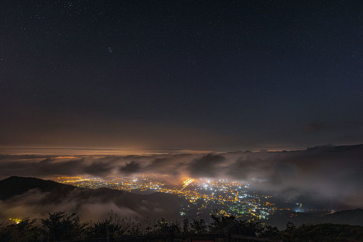 Starry night with sea of clouds over yuen long  kam tin area, tai mo shan mountain view, hong kong