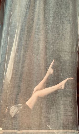 Shadow of woman hand on curtain