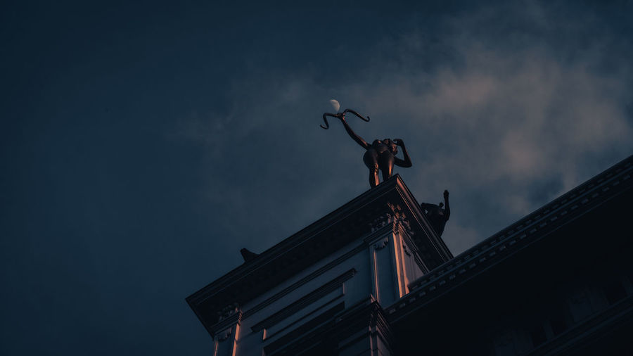 Statue of minerva in gran via. twice a month the full moon is pierced by minerva's arrow over madrid