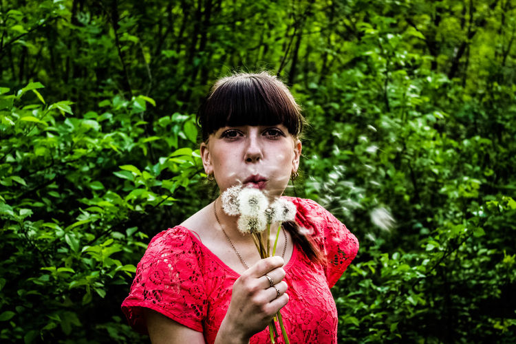Portrait of woman with dandelions