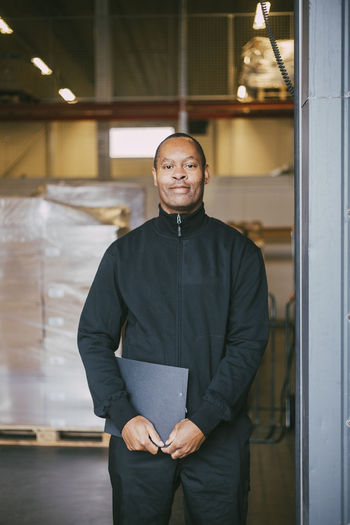 Portrait of smiling male manual worker at warehouse