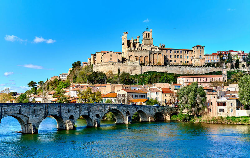 Pont vieux over orb river against beziers cathedral on sunny day