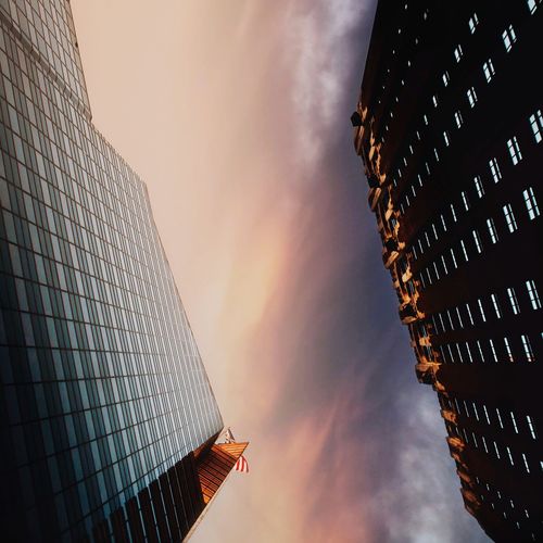 Directly below shot of modern building against sky during sunset
