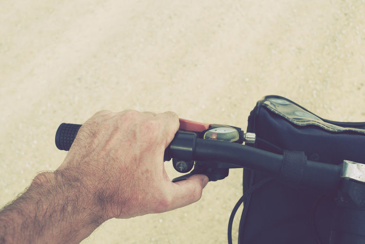 Close-up of man holding bicycle