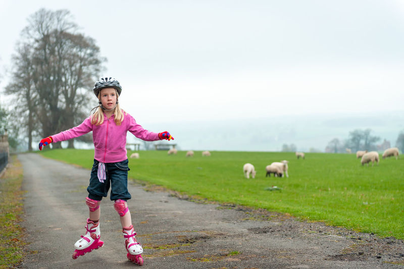 Full length of girl standing on field