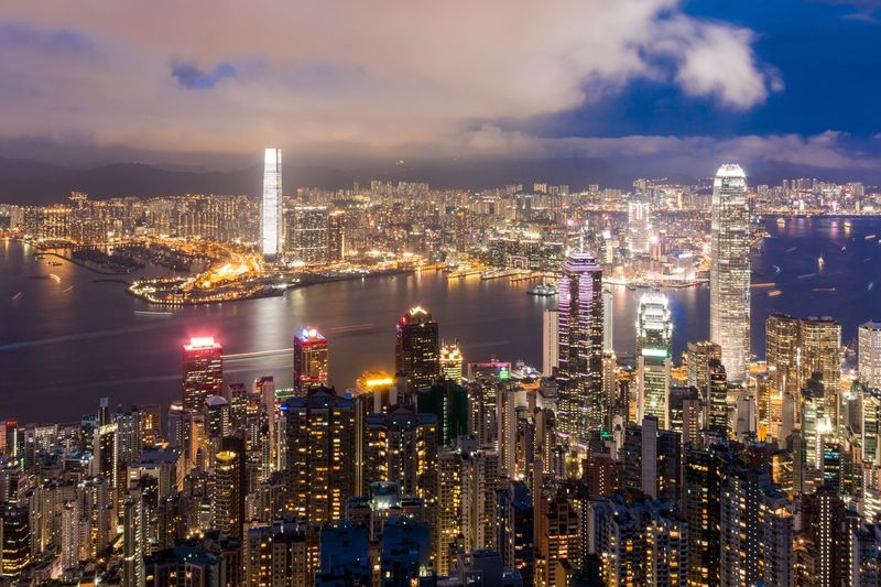 Illuminated cityscape against sky at night