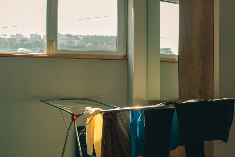View of clothes drying by window at home