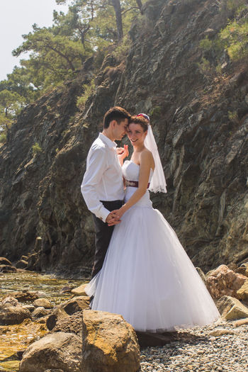 Rear view of couple kissing on rock