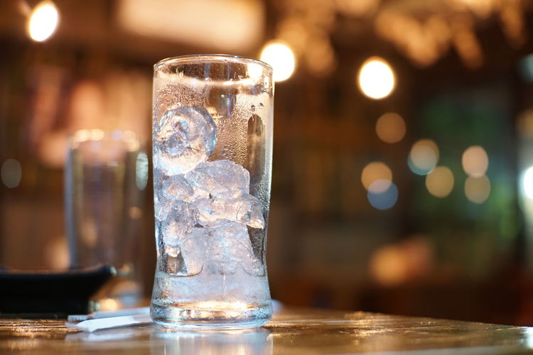 Close-up of ice in glass on table