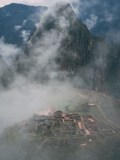 Aerial view of machu picchu ruins in foggy weather