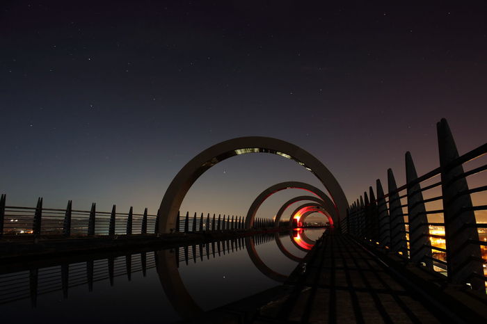 Falkirk wheel against sky at night