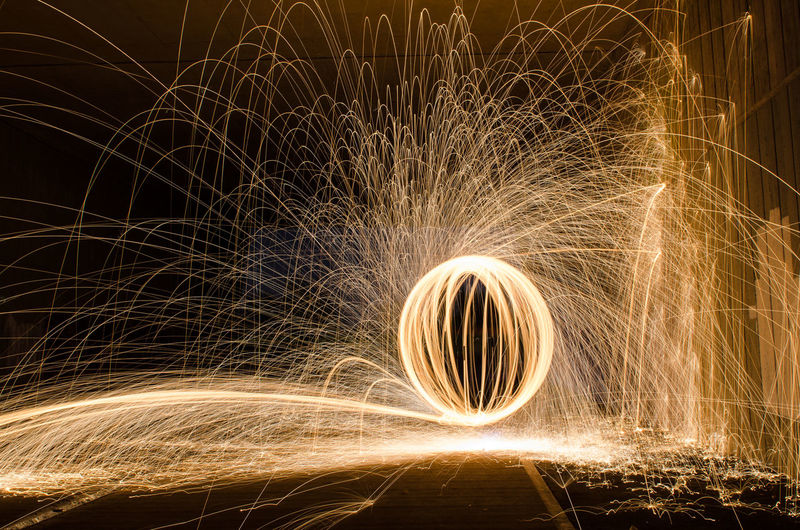 Illuminated wire wool against sky at night