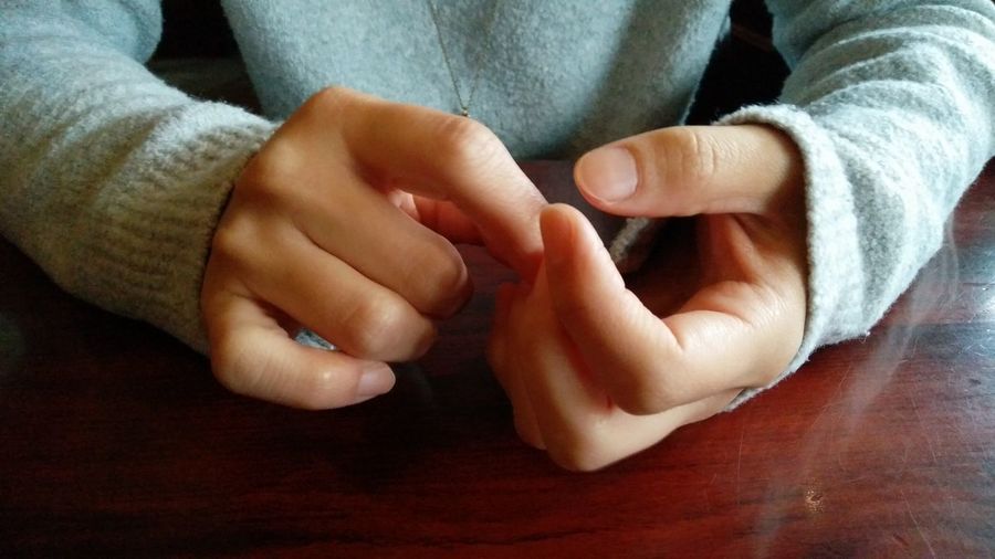 Midsection of couple holding hands