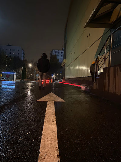 Surface level of wet road in city at night
