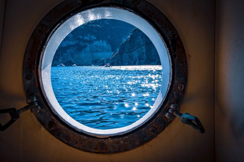 Close-up of sea seen through boat window