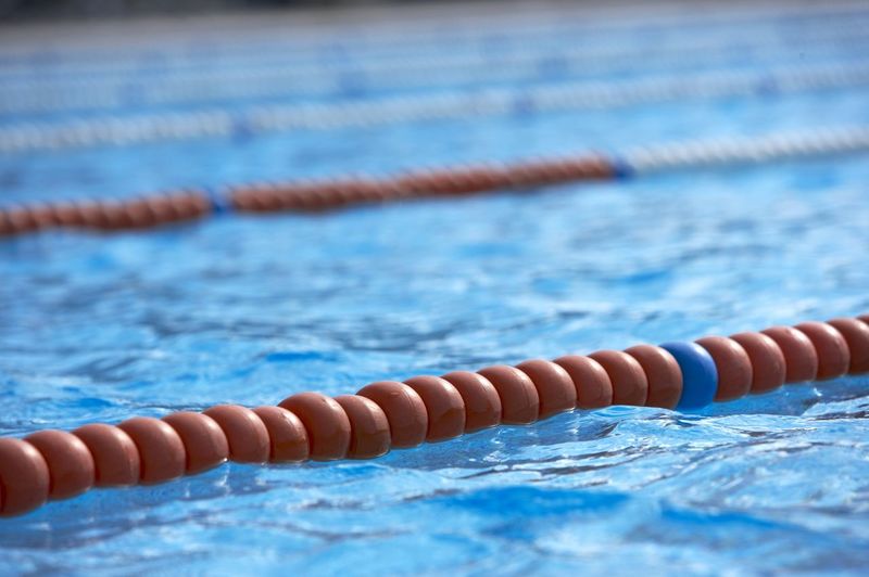 Close-up of person floating on swimming pool