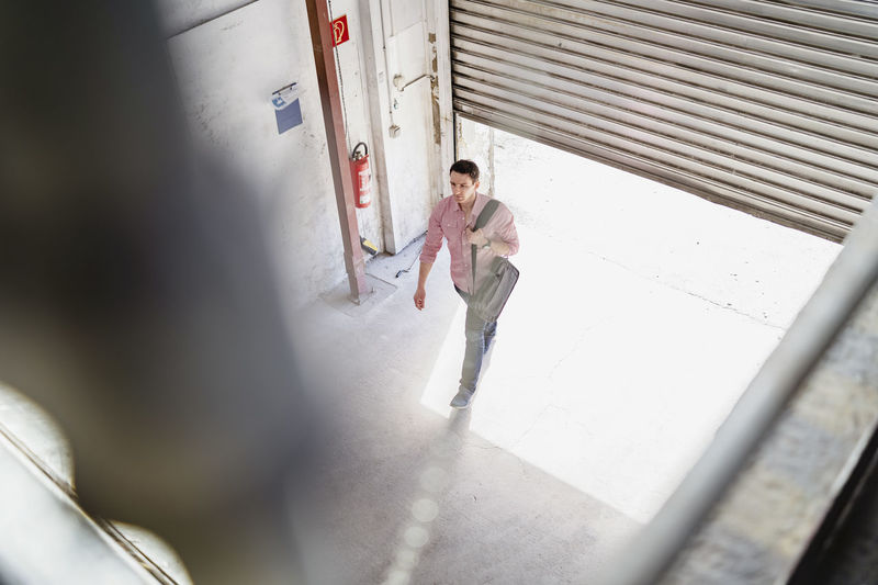 Bird's eye view of employee walking at loading bay in a factory