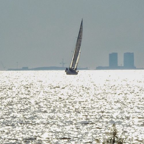 Ship sailing in sea against clear sky