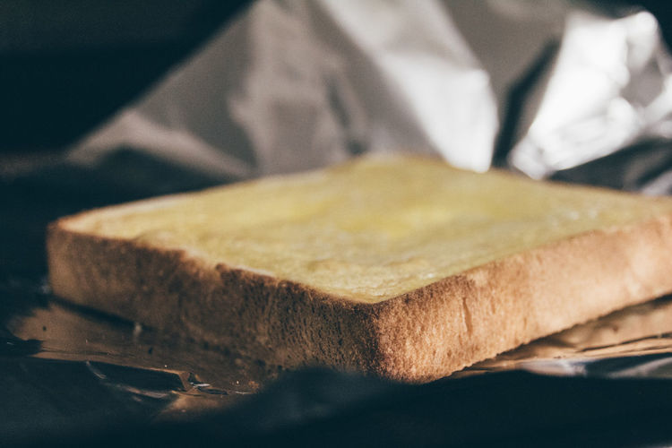Close-up of bread slice on foil