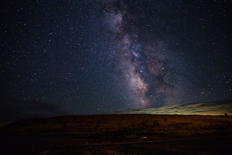 Scenic view of landscape against sky at night