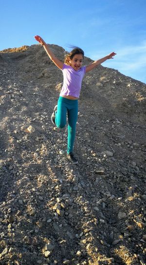 Full length of girl with arms raised