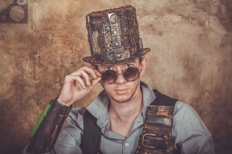 Portrait of steampunk man holding camera