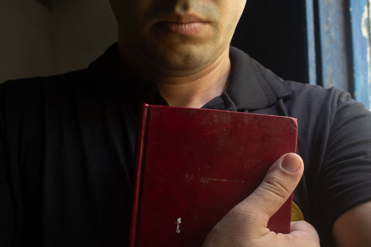 Close-up of man holding book