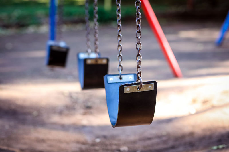Empty swings hanging at playground