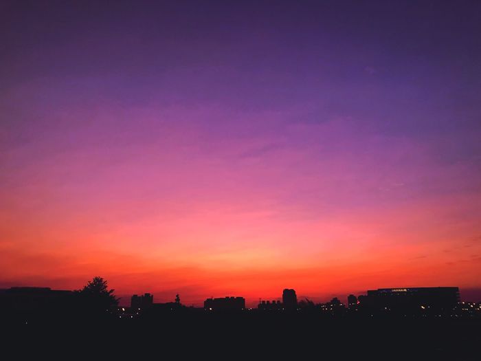 Silhouette buildings against sky during sunset