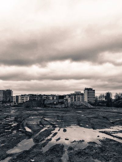 Abandoned city against cloudy sky