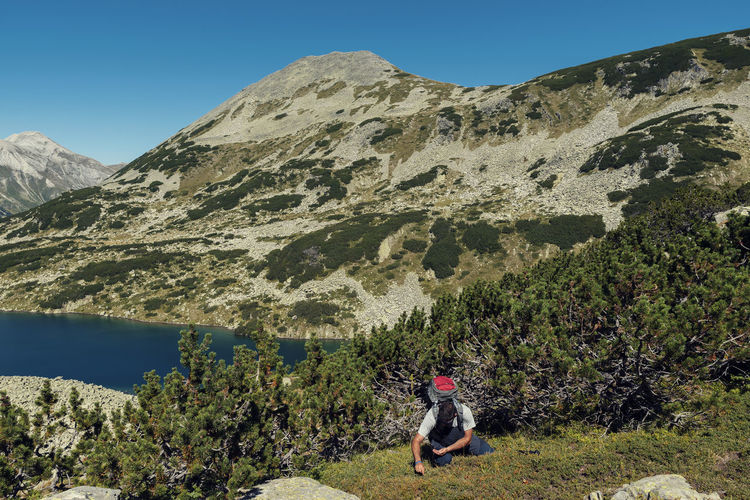 Woman on mountain against sky