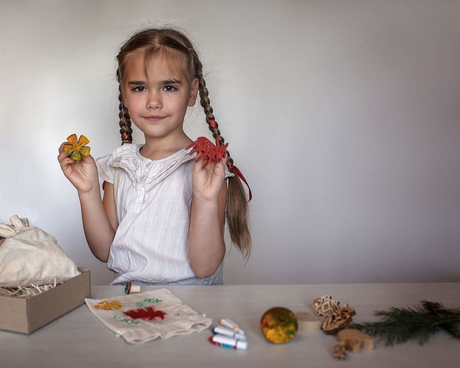 Portrait of young woman with christmas decoration on table