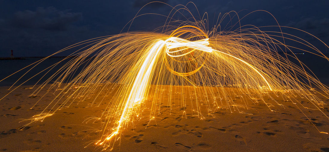 Light painting against sky at night