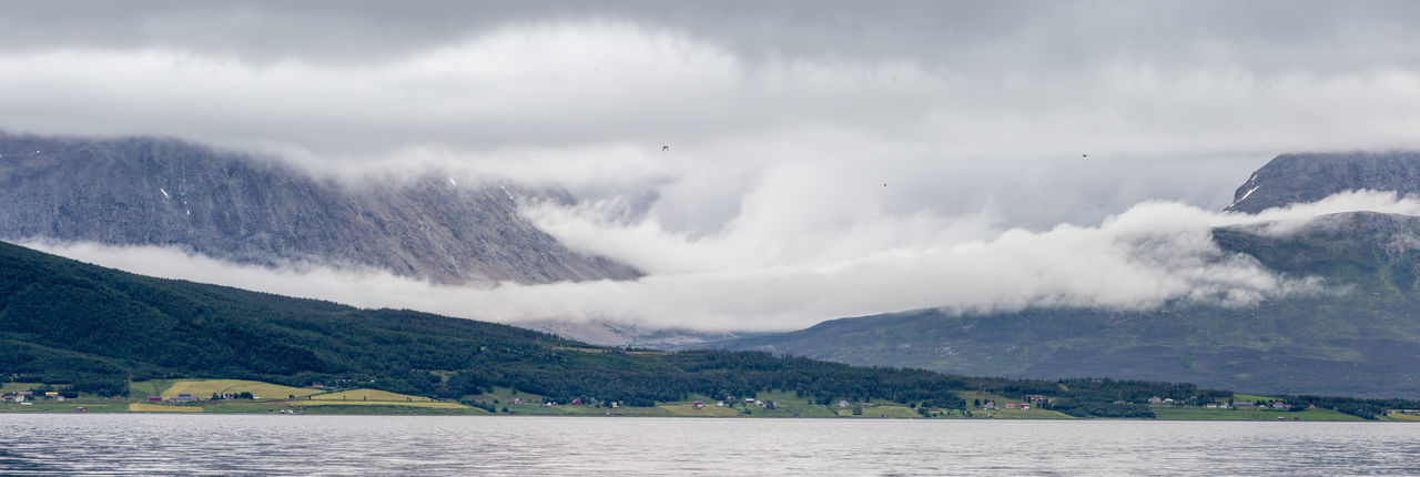 Panoramic shot of lyngen alps against cloudy sky