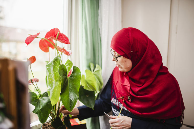 Woman taking care of plant