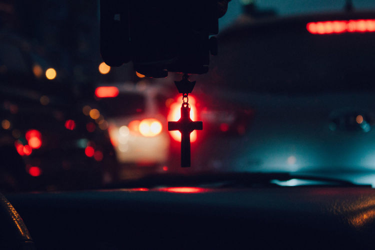 Close-up of cross hanging in car