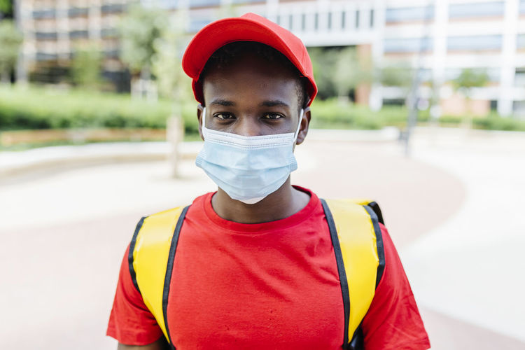 Delivery man wearing protective face mask during pandemic